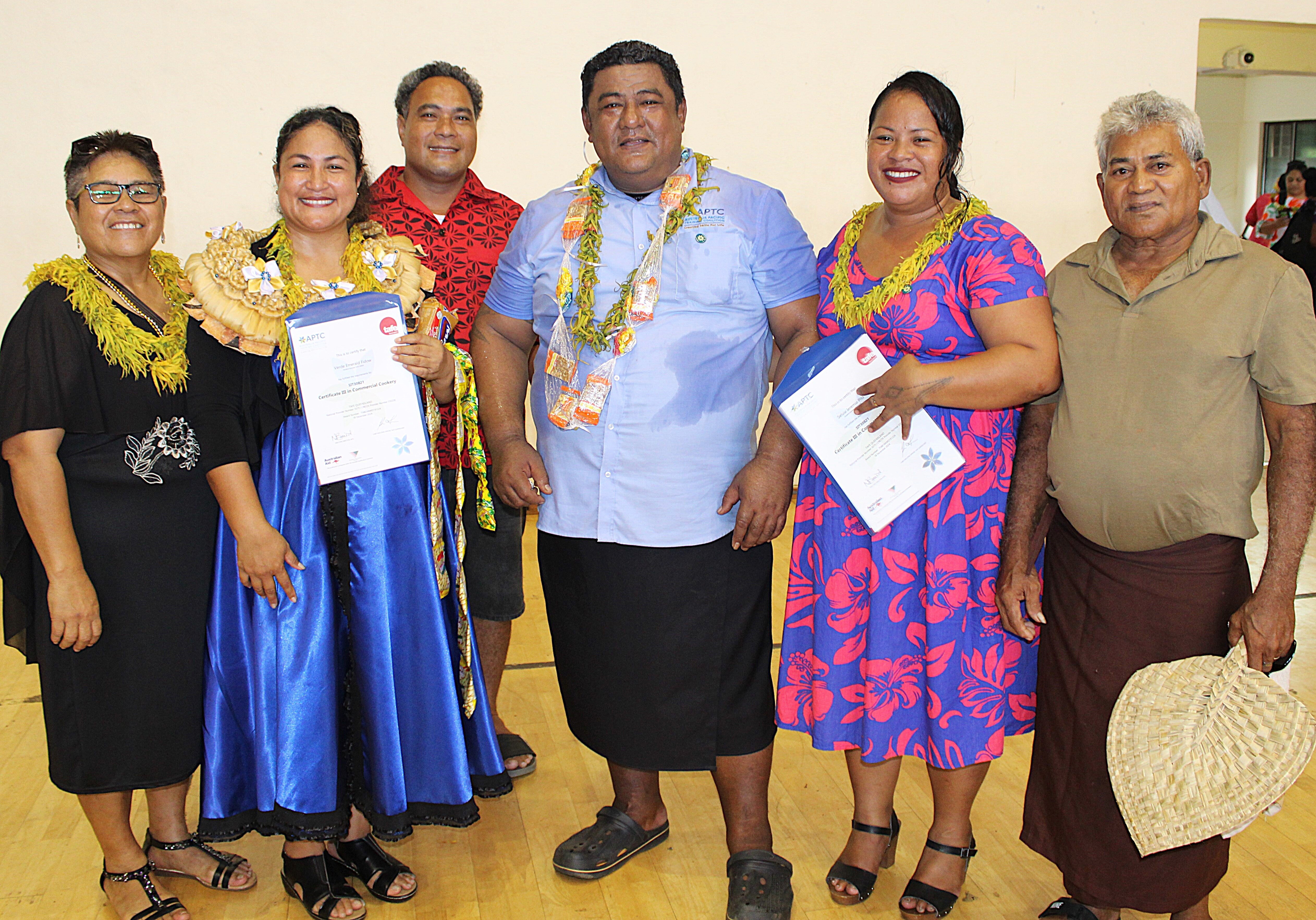 Photo 5 APTC Certificate III in Commercial Cookery Trainer, Aukusitino Suifaatau, with two graduates of the Certificate III in Commercial Cookery program and their families.