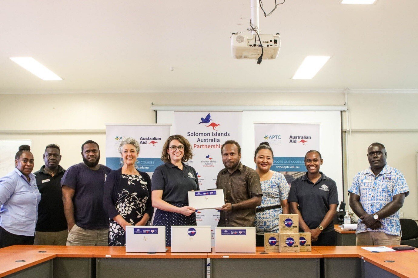 Mr Harry James Olikwailafa, the Solomon Islands National Youth Congress (SINYC) Chairperson, receiving ICT equipment during a formal handover with Australian High Commission representative, Monika Betts.