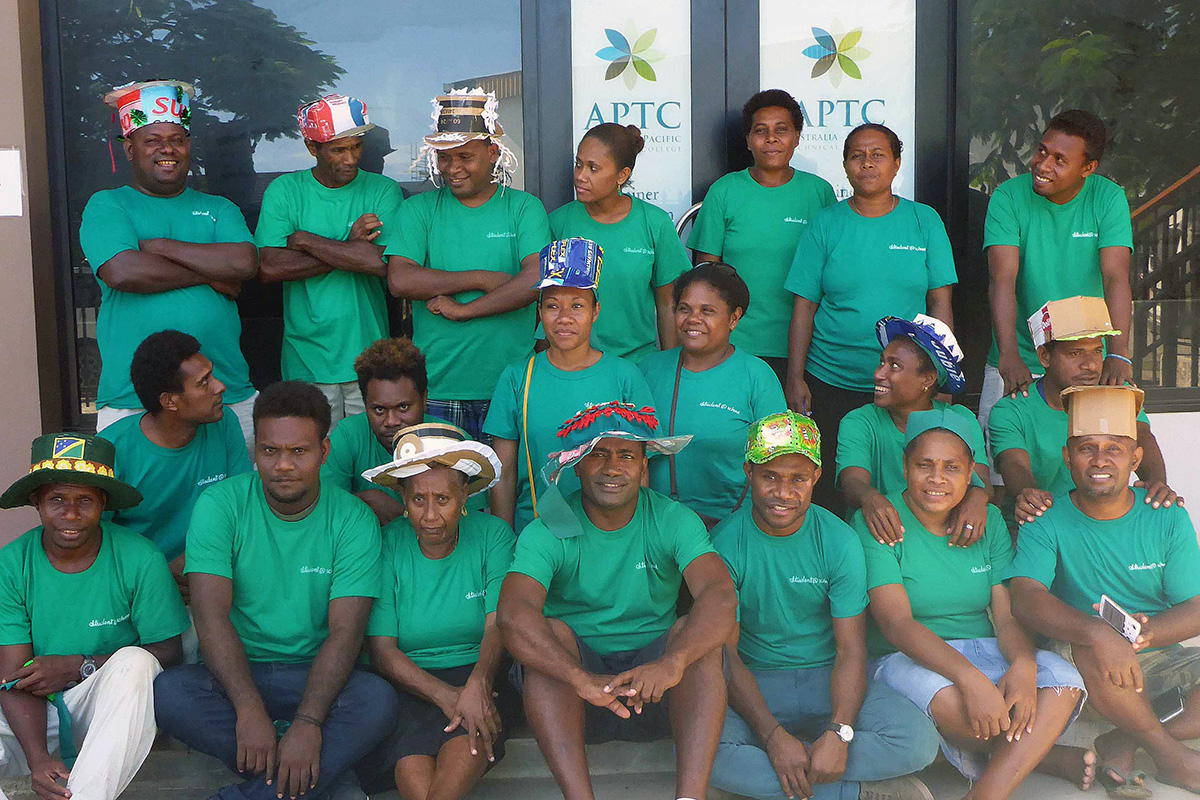 APTC Community Services students in Honiara, in their green outfits and hats.